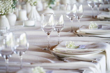 beautiful table setting with flowers and cutlery on wooden table at wedding or dinner. stylish tablewear decorations	