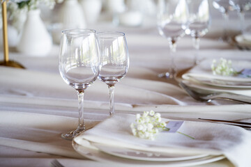 beautiful table setting with flowers and cutlery on wooden table at wedding or dinner. stylish tablewear decorations	