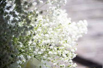White floral bouquet with roses and daisies arranged in elegant vase for wedding table decoration, natural fresh flowers as romantic festive centerpiece for ceremony, celebration and reception event