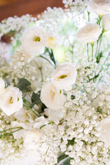 White floral bouquet with roses and daisies arranged in elegant vase for wedding table decoration, natural fresh flowers as romantic festive centerpiece for ceremony, celebration and reception event