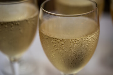 Elegant champagne glasses filled with sparkling wine on a festive celebration table, close up view of luxury drink serving for wedding banquet, party toast, event catering and reception ceremony