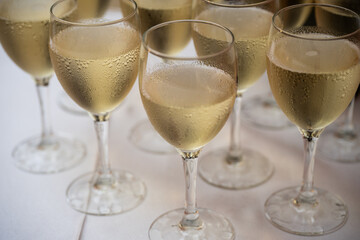 Elegant champagne glasses filled with sparkling wine on a festive celebration table, close up view of luxury drink serving for wedding banquet, party toast, event catering and reception ceremony