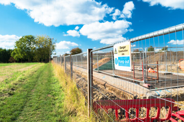 Newly erected Keep Out sign seen at the perimeter of a new housing development project in Britain. A farm field was sold for new housing in a typical British town.