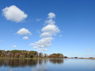 The scenic beauty of the wetlands, during the autumn season. Bombay Hook National Wildlife Refuge, Kent County Delaware. Natural reflections on calm water.
