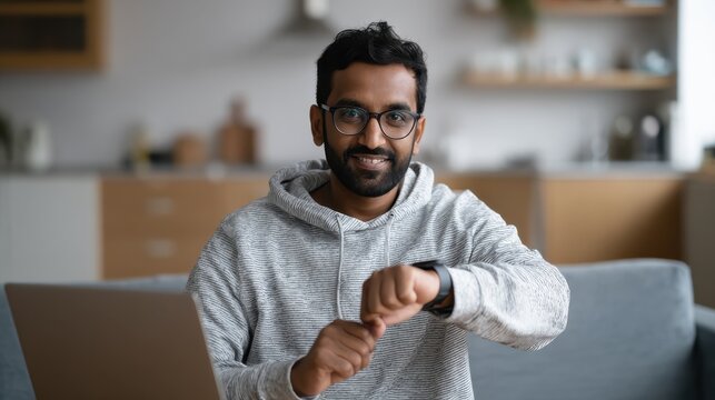 technology health and people concept  indian man recording video review of smart watch with or code on screen at home and making soso gesture no logos no brands ar 169