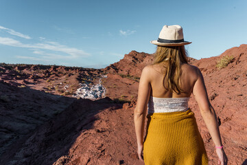 Woman exploring red desert landscape on a sunny day