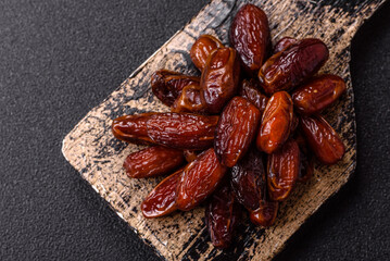 Dried dates in a ceramic plate, arabic food for the ramadan table. Dried dates as a food backgrounds