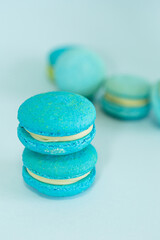 Fototapeta premium few of a blue colored macaroons on a flat blue background