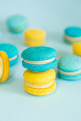 Blue and yellow macaroons on a solid blue background