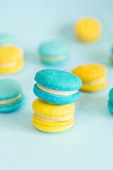 Blue and yellow macaroons on a solid blue background
