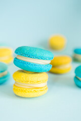 Blue and yellow macaroons on a solid blue background