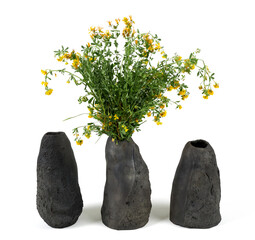 Three handmade ceramic vase with a bouquet of flowers isolated on white background.