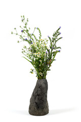 Handmade ceramic vase with a bouquet isolated on white background.