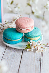 3 pink and blue macaroons served on a wooden table, in spring d?cor. Gender Reveal Party table