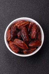 Dried dates in a ceramic plate, arabic food for the ramadan table. Dried dates as a food backgrounds