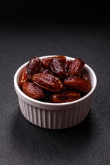 Dried dates in a ceramic plate, arabic food for the ramadan table. Dried dates as a food backgrounds