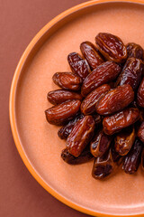 Dried dates in a ceramic plate, arabic food for the ramadan table. Dried dates as a food backgrounds