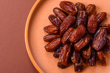 Dried dates in a ceramic plate, arabic food for the ramadan table. Dried dates as a food backgrounds