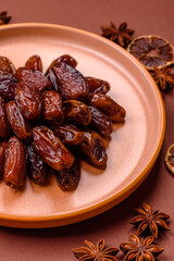 Dried dates in a ceramic plate, arabic food for the ramadan table. Dried dates as a food backgrounds