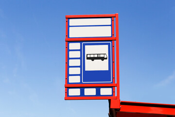 Bus stop sign with red frame. Public transport symbol against blue sky. Minimalist design with...