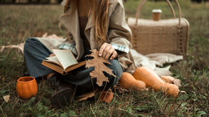 Autumn picnic with a book and pumpkins