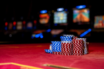 Stacks of playing chips on casino table. Chips for poker on shiny background. Poker game. Casino...