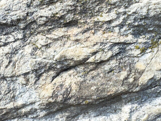 Close-up of rough textured rock surface with natural patterns