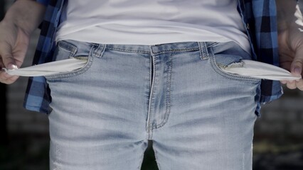 man shows empty pockets, crisis, bankruptcy and business zeroing, no money to pay credit, unemployment and poverty, life in debt, finance desperate inflation, the concept of impoverishment of people.