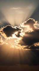 Golden sunlight pierces through dark clouds, casting dramatic rays across the sky.