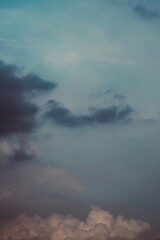 Storm horizon with glowing pastel light above clouds