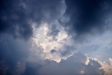 Storm clouds parting with light breaking through the sky