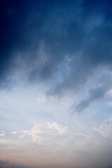 Soft pastel sky with clouds drifting under blue light