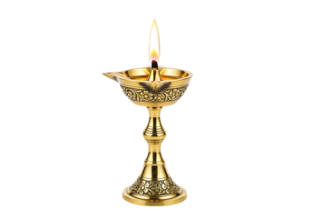 Ornate golden indian oil lamp with a lit flame and intricate carvings isolated on transparent background