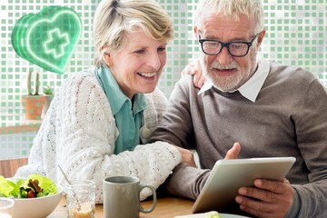 Happy senior couple using tablet remix