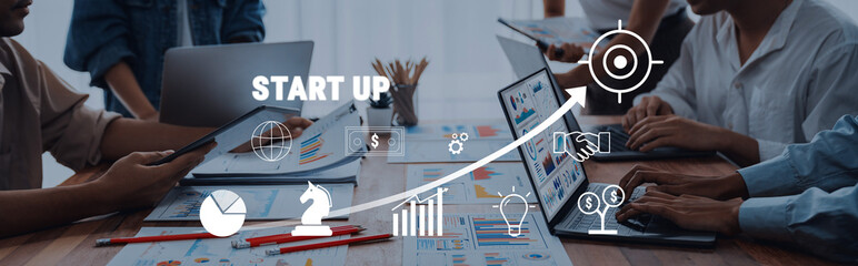 A dynamic startup team collaborates over digital devices in a modern office, showcasing strategies...