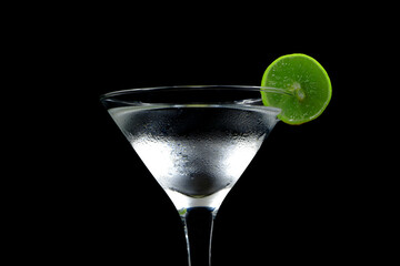 Ice water with lemon closeup shot on black background 