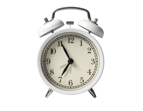 A vintage-style white alarm clock displays a specific time against a black backdrop.