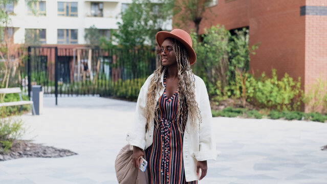 A woman uses a city map and geolocation on her smartphone to navigate the area while traveling.
