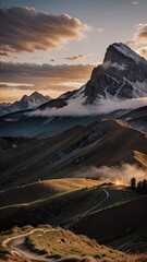 Mountainous landscape with snowcapped peaks rolling hills and a winding path