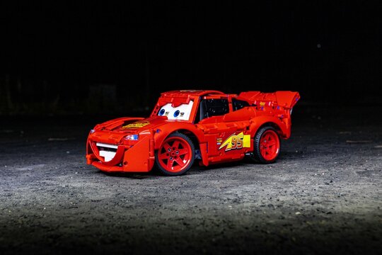 red toy car Lego Lightning McQueen detail logo black isolated
