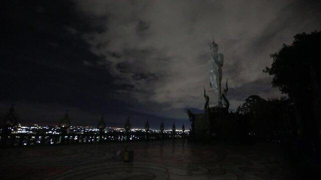 Video background of Chonburi city viewpoint. At the Samnaksong Khao Phra Khru viewpoint in the Sri Racha Thailand,a beautiful Naga statue and a white Buddha statue stand tall among the mountains.