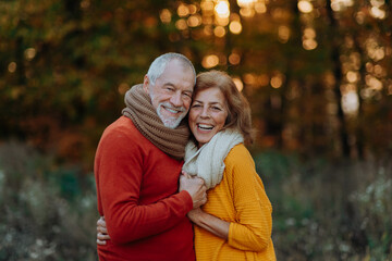Fototapeta premium Portrait of senior couple in autumn nature.