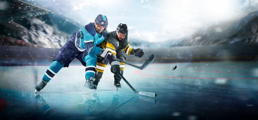 Hockey plaers in action. Professional forward player masterfully puck. Breaks defense, ready to hit the puck with stick to score a goal. Important and tension moment. Sport. Ice hockey rink arena