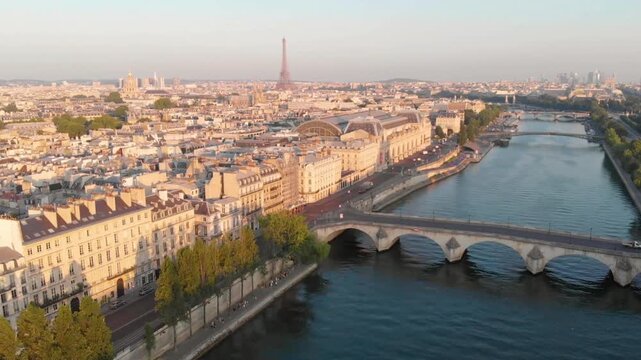 An aerial view of paris with the seine river and eiffel tower in the distance