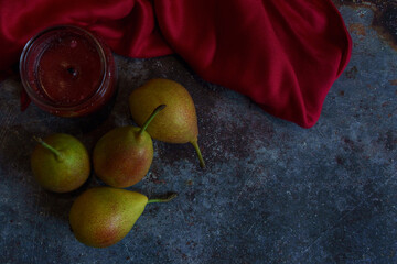 Moody composition with pears and a candle. 