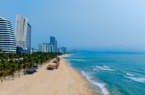 Scenic coastal view of Da nang beach with modern skyscrapers and palm trees