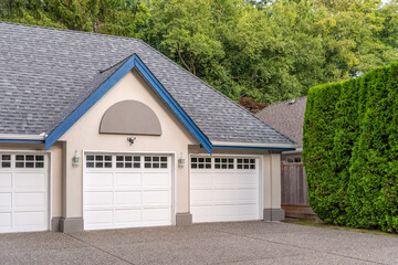 Garage door in luxury house with trees and nice landscape in Summer in Vancouver, Canada, North America. Day time on August 2025.