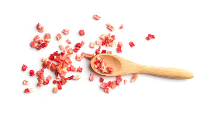 Wooden spoon with diced strawberry pieces on white background