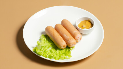 Boiled sausages on plate isolated