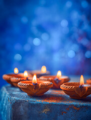 Vibrant Diwali Diyas on a Blue Background